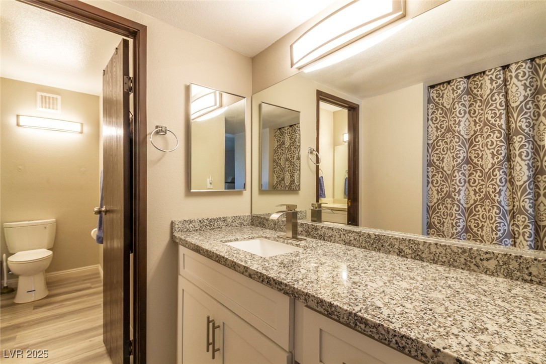 730 South Royal Crest Circle, Unit 421 Las Vegas, NV 89169 - Photo 12 of 21 Full bath with vanity and light wood-style floorin