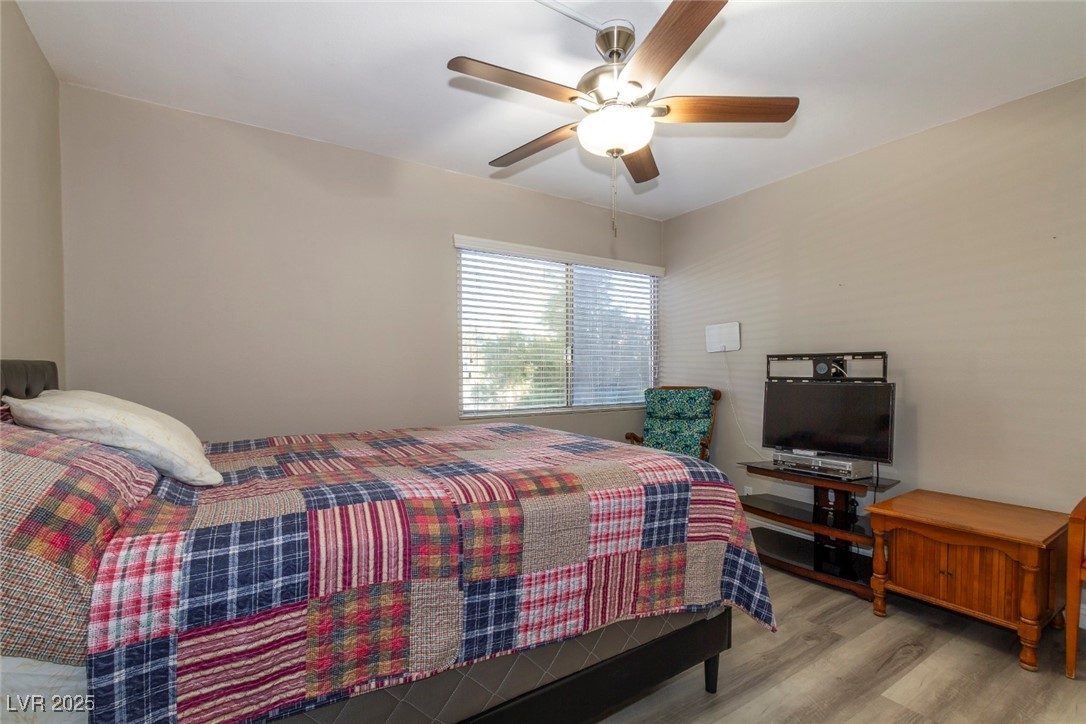 730 South Royal Crest Circle, Unit 421 Las Vegas, NV 89169 - Photo 14 of 21 Bedroom featuring wood finished floors and a ceili