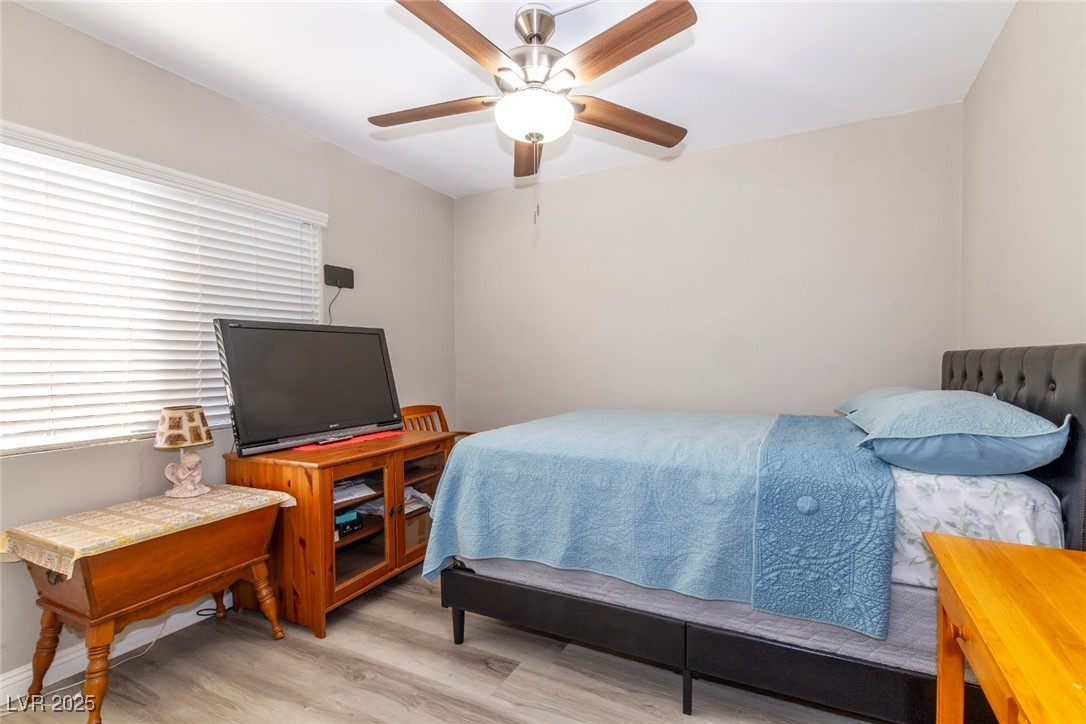 730 South Royal Crest Circle, Unit 421 Las Vegas, NV 89169 - Photo 16 of 21 Bedroom featuring light wood-style floors and a ce