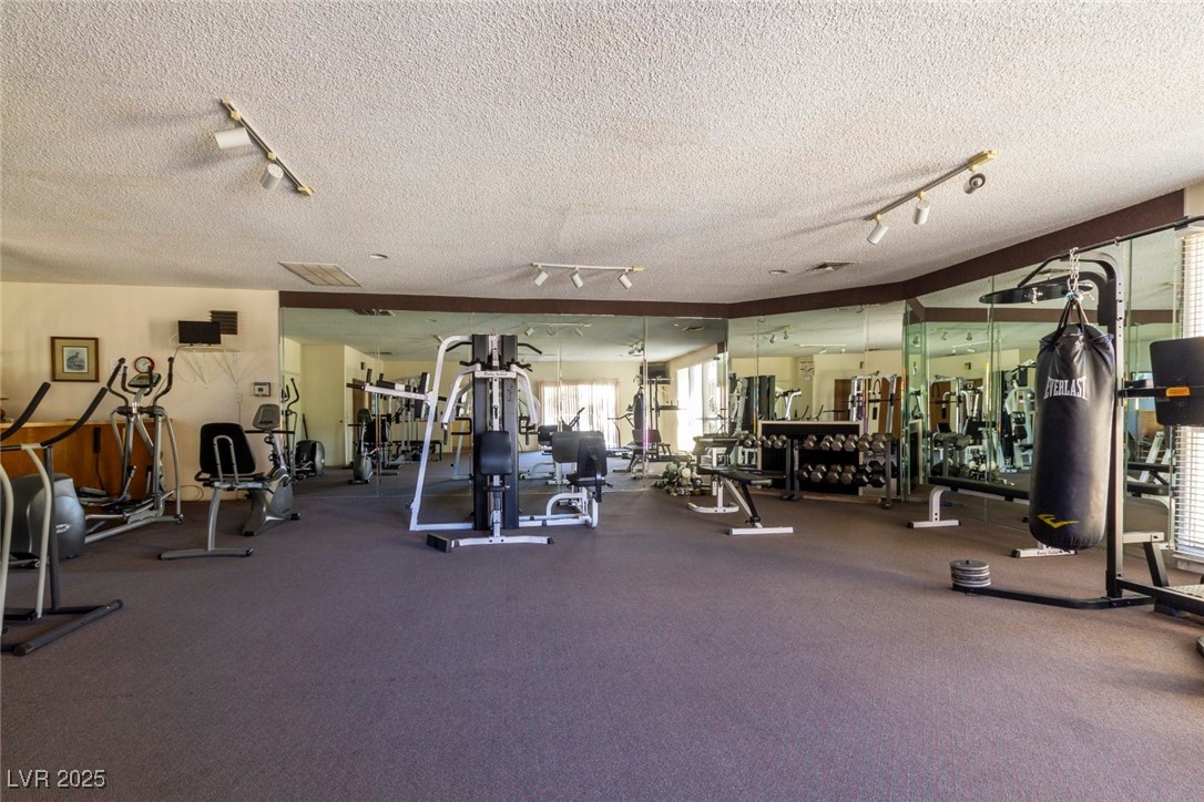 730 South Royal Crest Circle, Unit 421 Las Vegas, NV 89169 - Photo 20 of 21 Gym featuring rail lighting and a textured ceiling