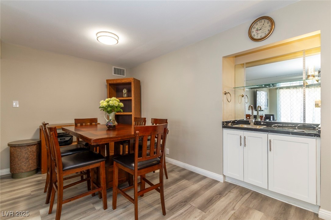 730 South Royal Crest Circle, Unit 421 Las Vegas, NV 89169 - Photo 5 of 21 Dining area with light wood-type flooring and base