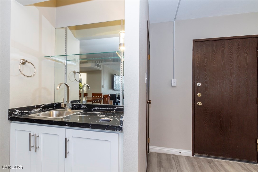 730 South Royal Crest Circle, Unit 421 Las Vegas, NV 89169 - Photo 6 of 21 Kitchen with white cabinets, light wood-type floor