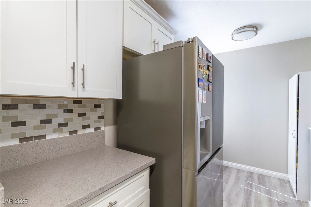 730 South Royal Crest Circle, Unit 421 Las Vegas, NV 89169 - Photo 9 of 21 Kitchen with white cabinets, stainless steel refri