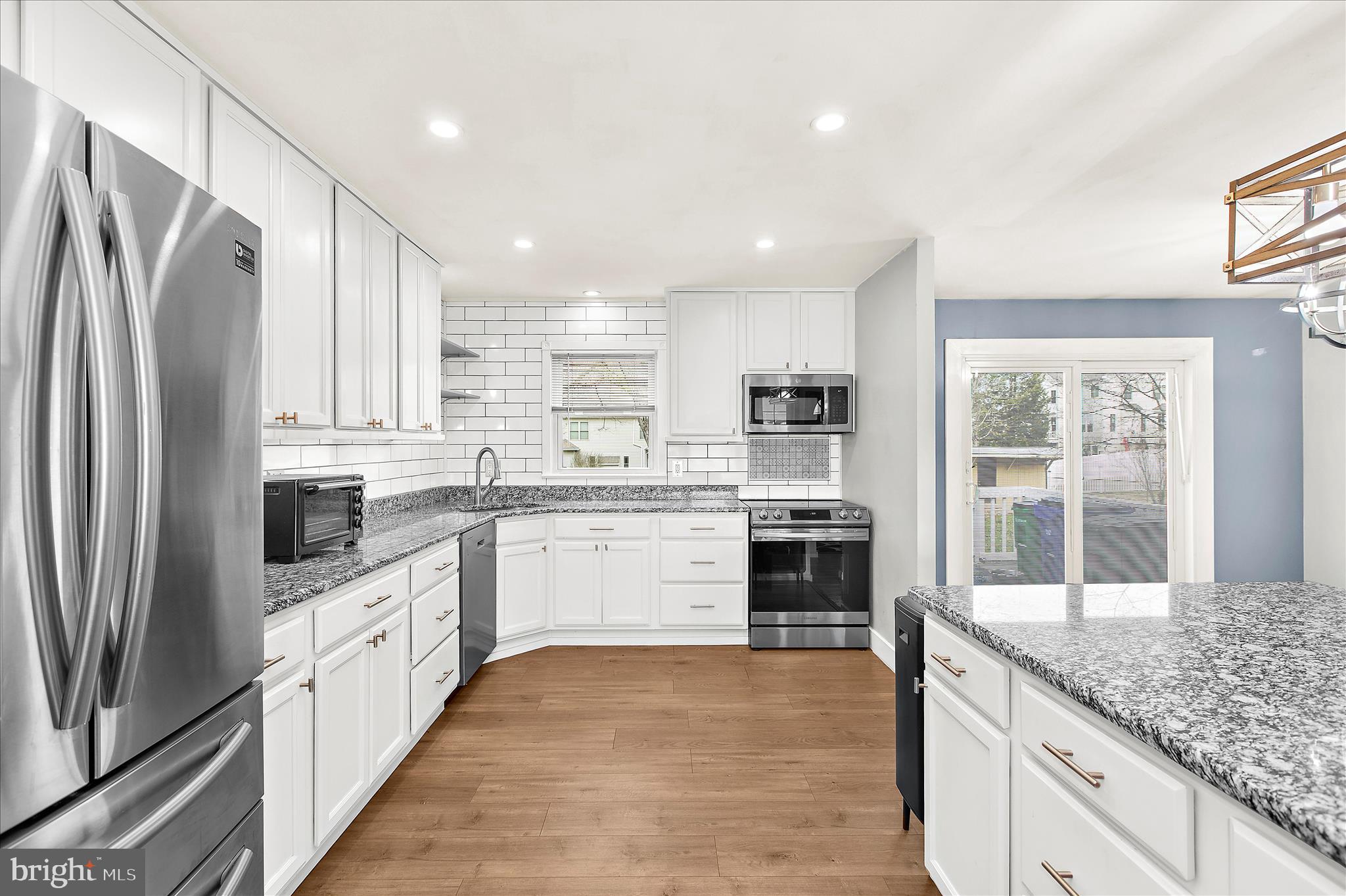 9140 Vollmerhausen Road Savage, MD 20794 - Photo 11 of 49 a large kitchen with granite countertop a large counter top appliances and cabinets