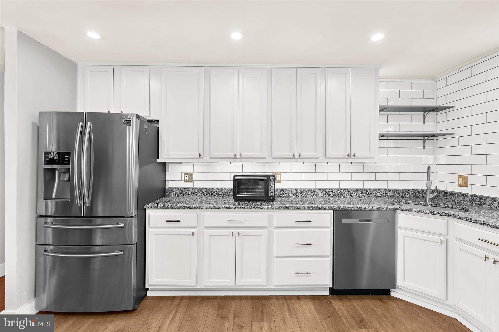 9140 Vollmerhausen Road Savage, MD 20794 - Photo 13 of 49 a kitchen with granite countertop a refrigerator sink and cabinets