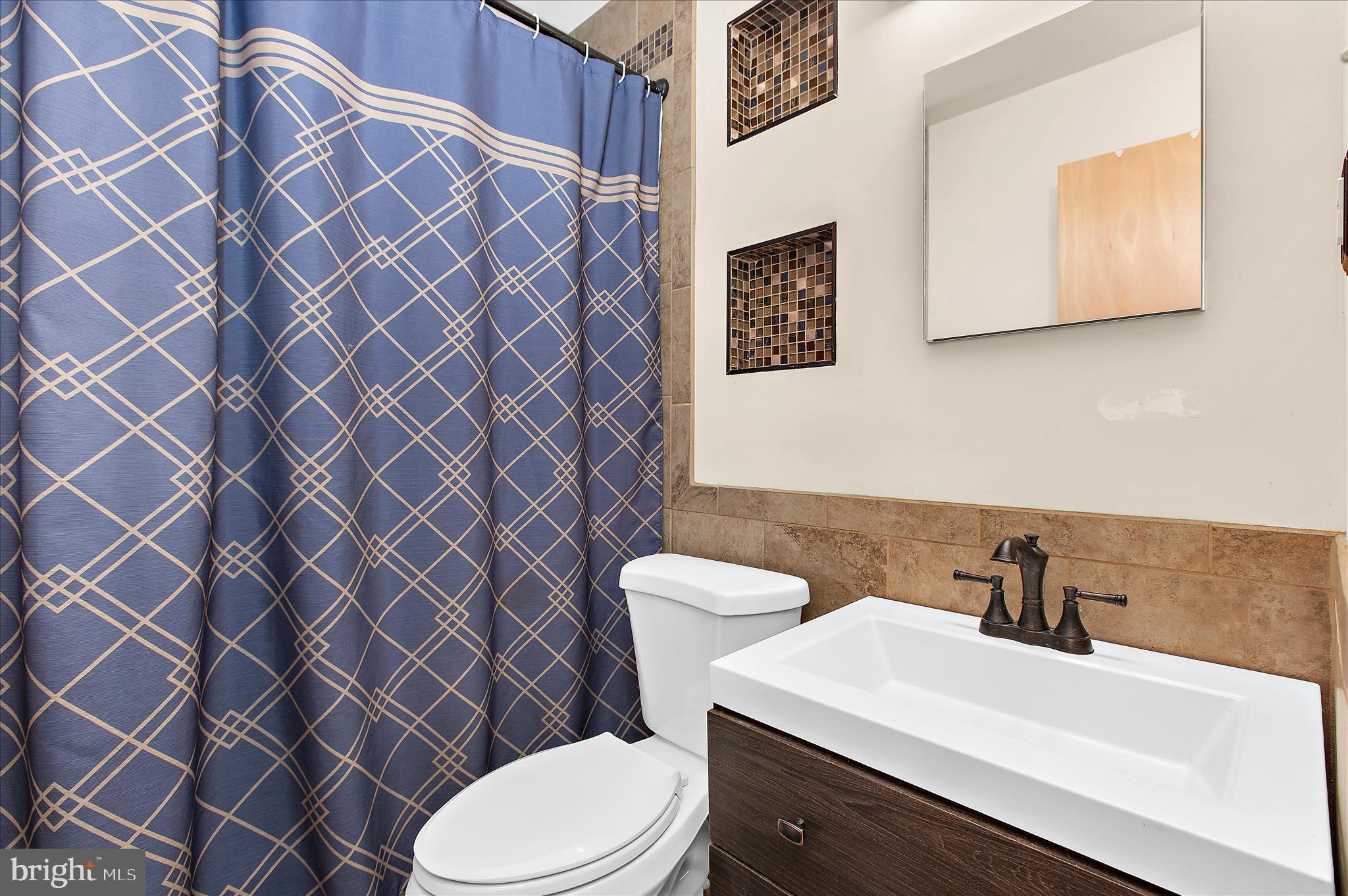 9140 Vollmerhausen Road Savage, MD 20794 - Photo 16 of 49 a bathroom with a sink toilet and mirror