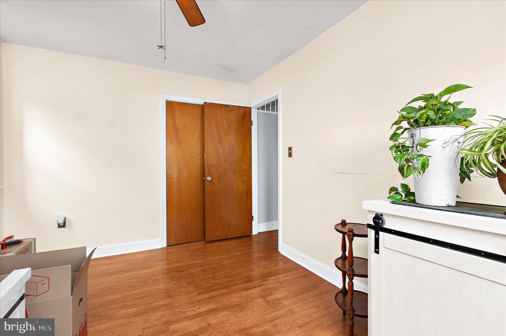 9140 Vollmerhausen Road Savage, MD 20794 - Photo 20 of 49 a view of a hallway with wooden floor and a potted plant