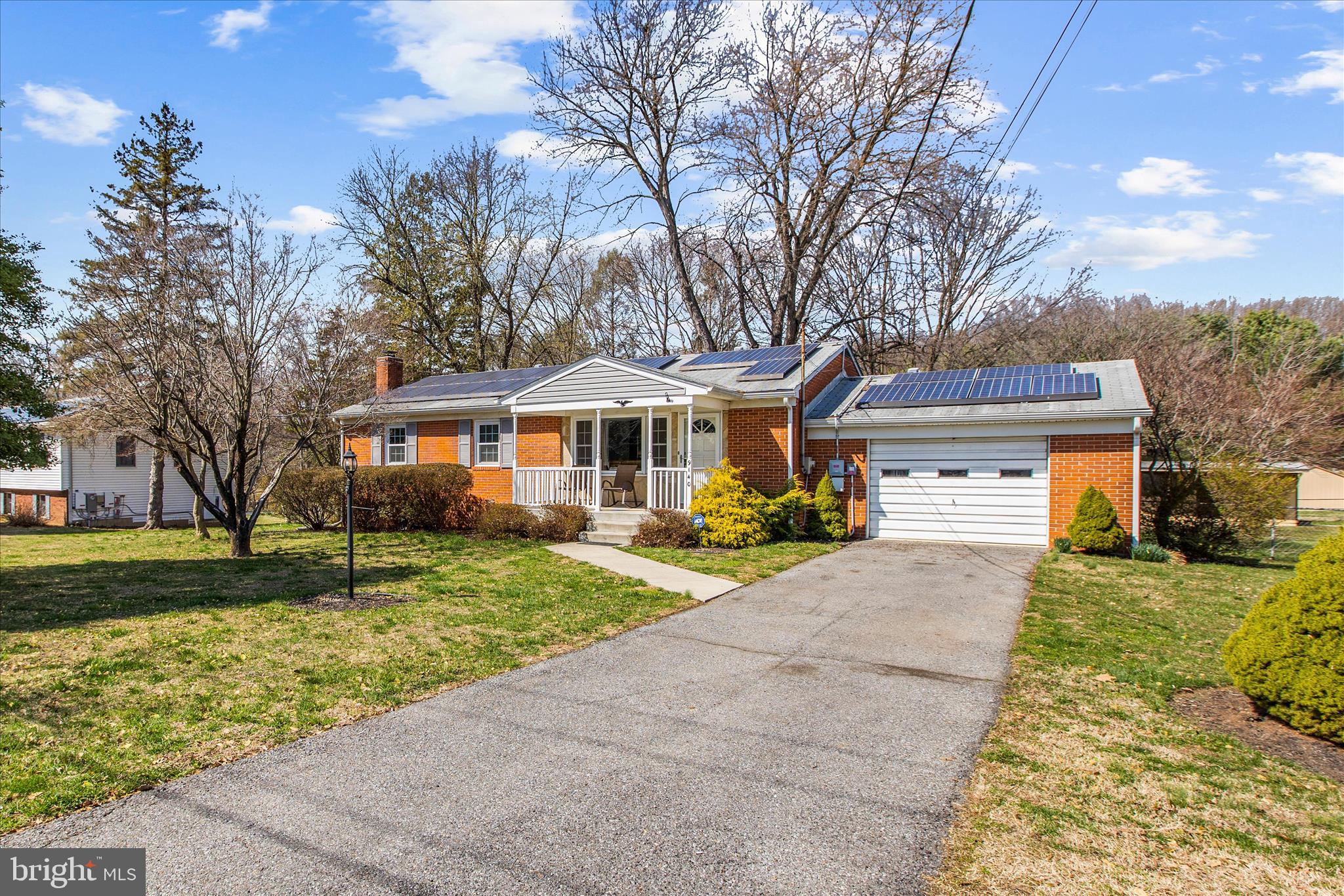 9140 Vollmerhausen Road Savage, MD 20794 - Photo 2 of 49 a front view of a house with a yard and garage