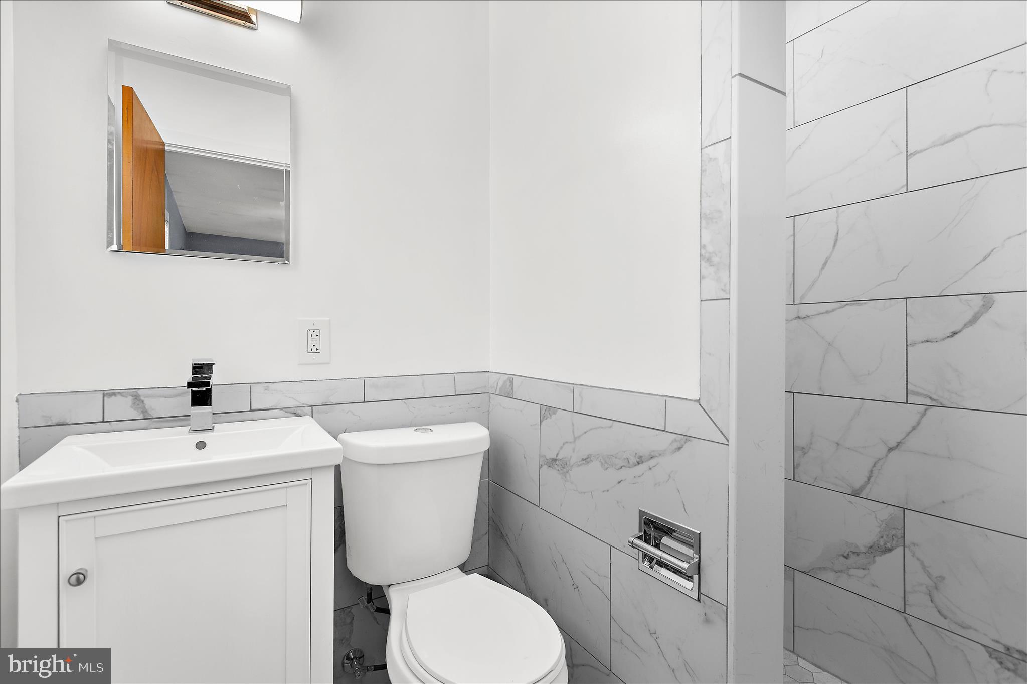 9140 Vollmerhausen Road Savage, MD 20794 - Photo 21 of 49 a bathroom with a toilet sink and mirror