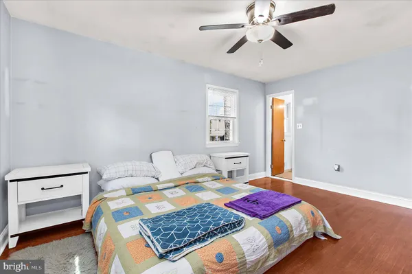 a bedroom with a bed and ceiling fan