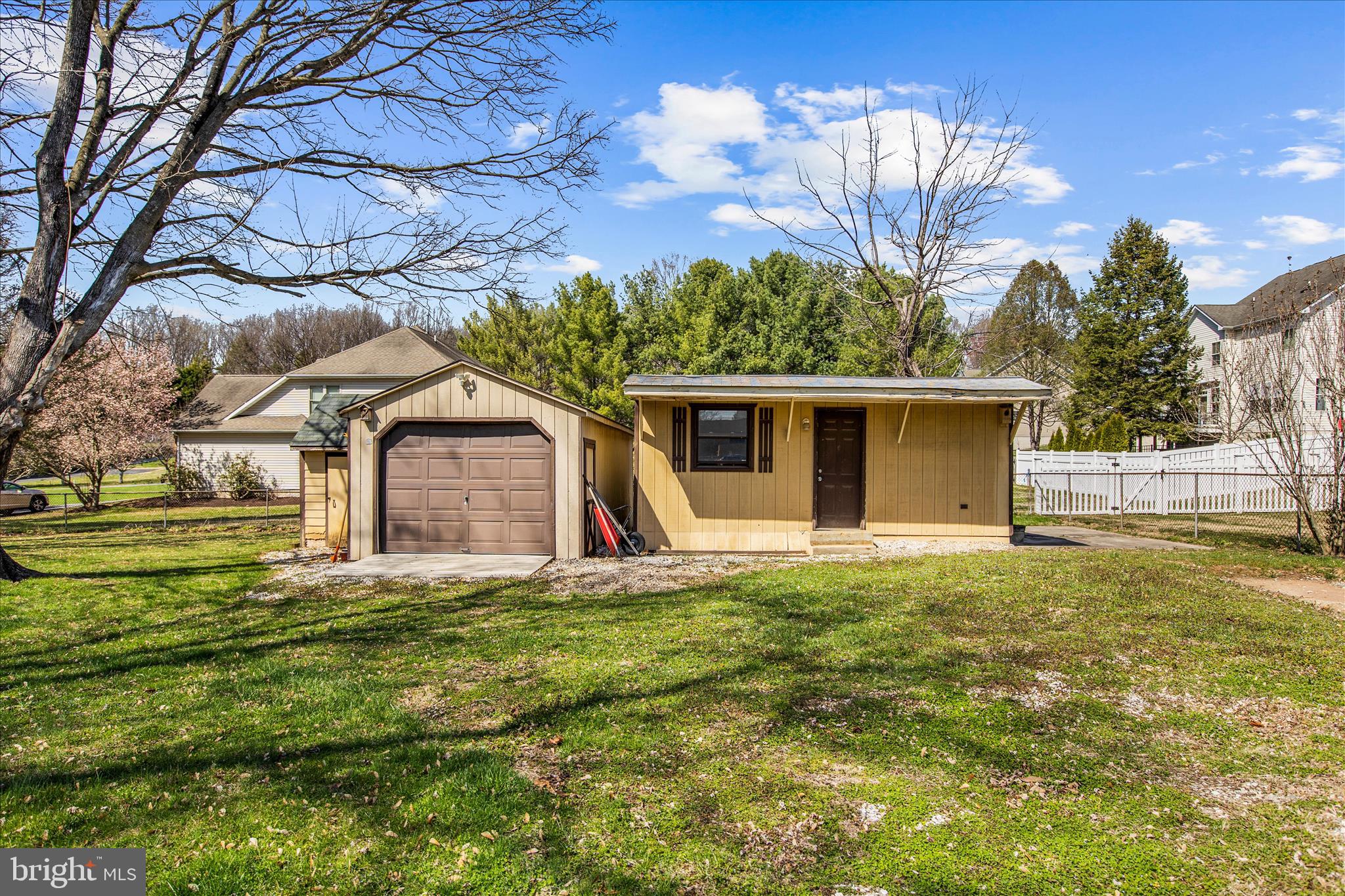 9140 Vollmerhausen Road Savage, MD 20794 - Photo 40 of 49 a large tree in front of a house with a garden