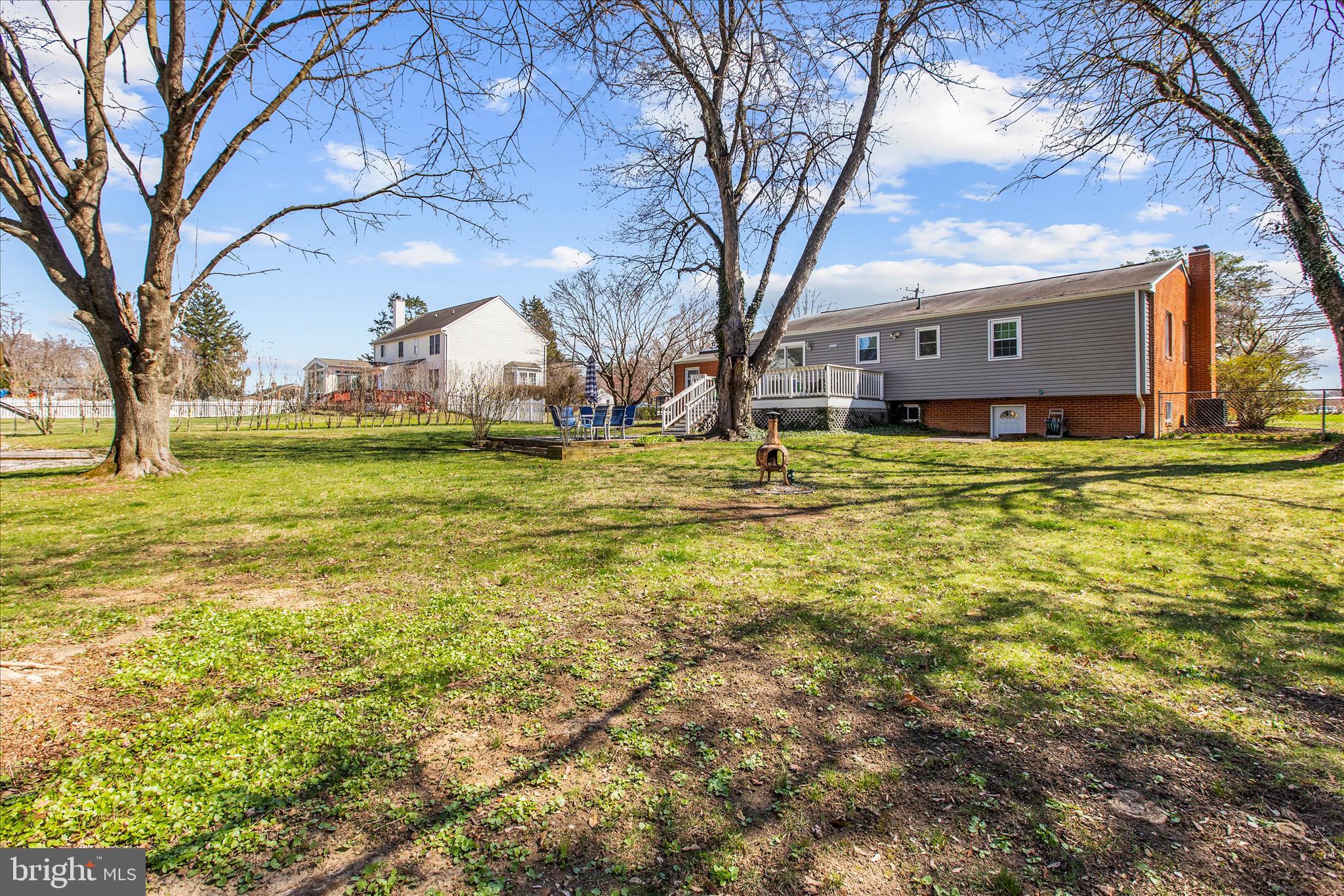 9140 Vollmerhausen Road Savage, MD 20794 - Photo 44 of 49 a backyard of a house with large trees and outdoor seating