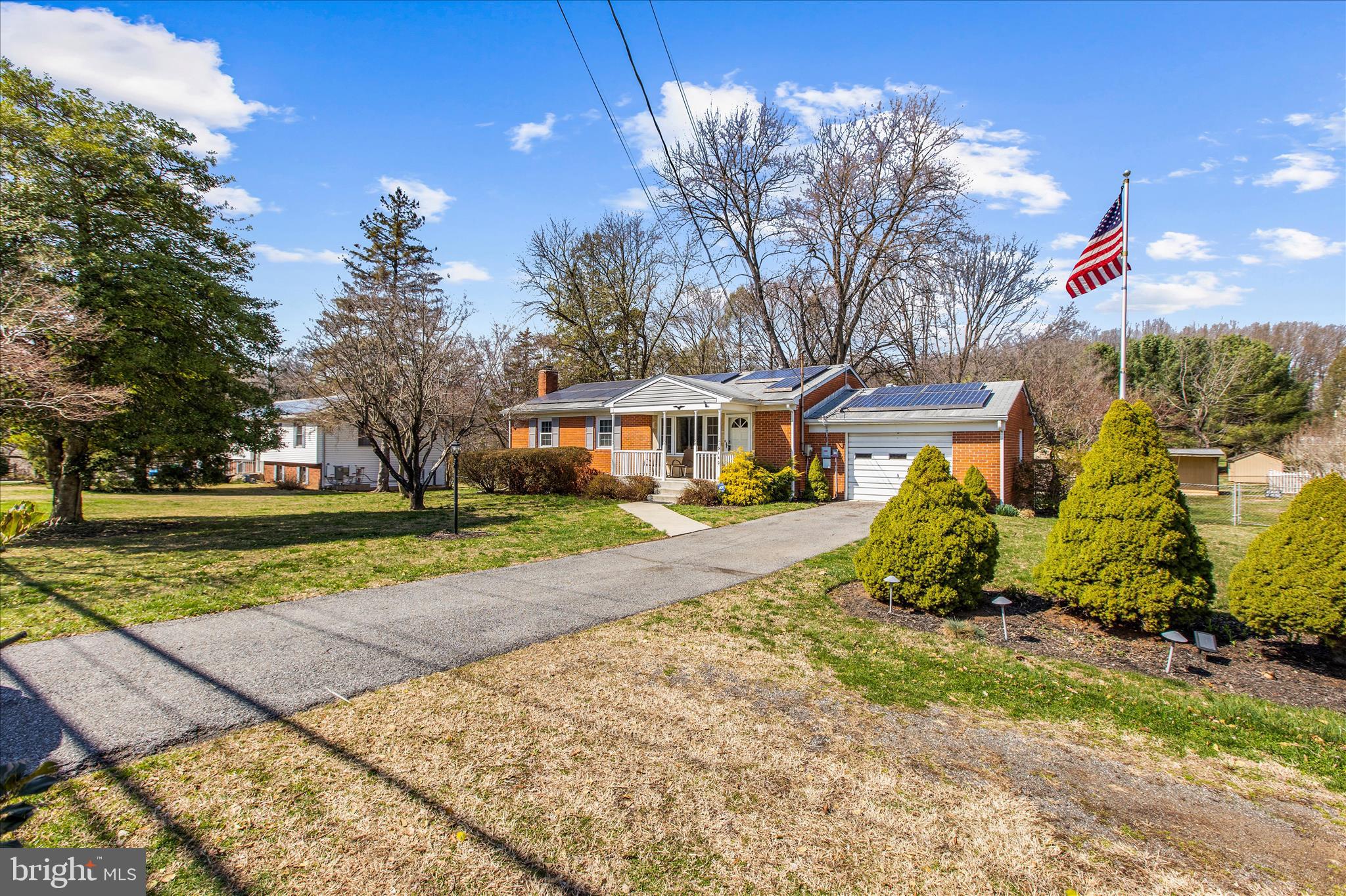 9140 Vollmerhausen Road Savage, MD 20794 - Photo 48 of 49 a front view of a house with a yard and large trees
