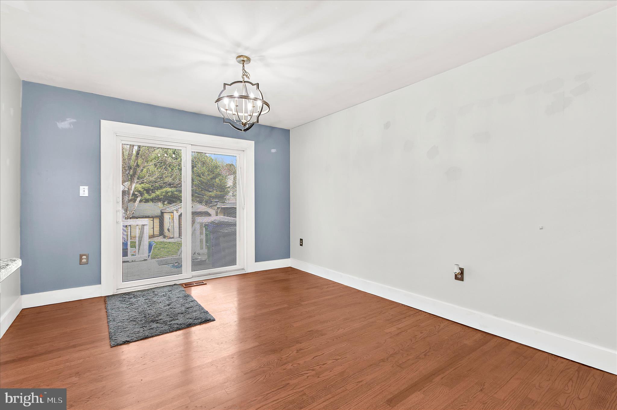 9140 Vollmerhausen Road Savage, MD 20794 - Photo 6 of 49 a view of an empty room with wooden floor and a window