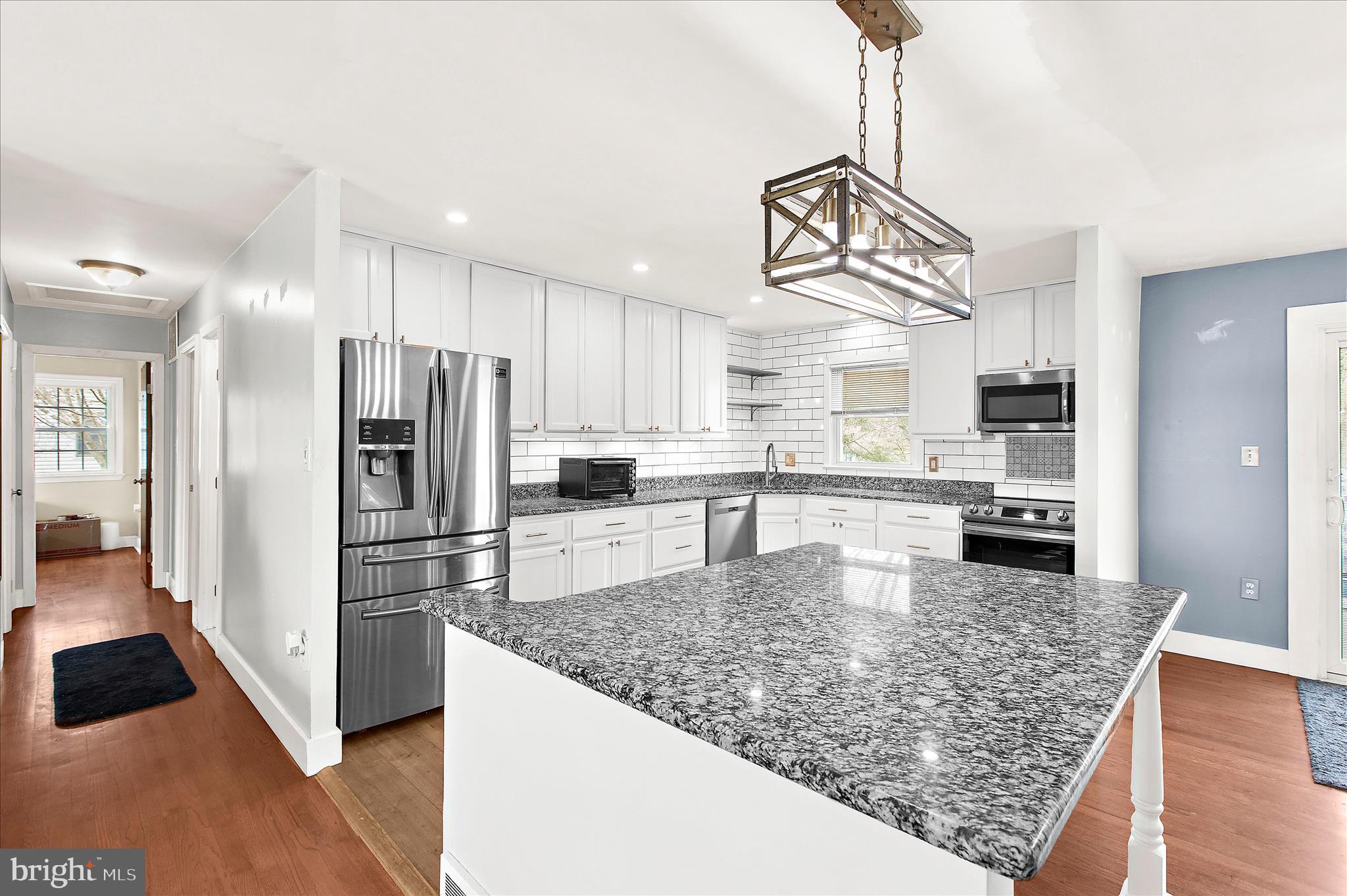 9140 Vollmerhausen Road Savage, MD 20794 - Photo 10 of 49 a kitchen with stainless steel appliances granite countertop a refrigerator a stove top oven a sink dishwasher and white cabinets