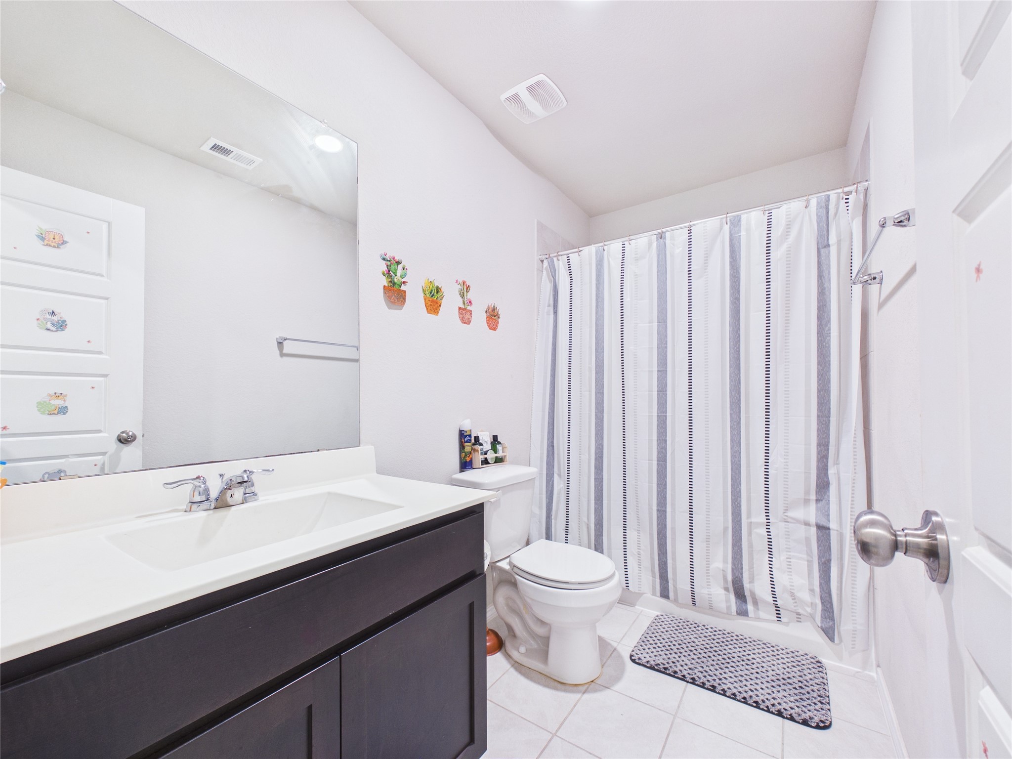 1237 Steed Bluff Drive Alvin, TX 77511 - Photo 38 of 50 a bathroom with a sink a toilet and shower curtain