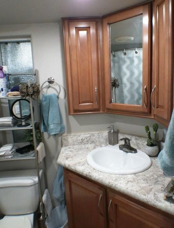 84136 Ave 44, Unit 125 Indio, CA 92203 - Photo 44 of 71 a bathroom with a granite countertop sink and a mirror