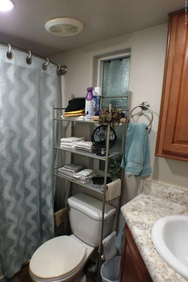 84136 Ave 44, Unit 125 Indio, CA 92203 - Photo 46 of 71 a bathroom with a granite countertop toilet sink and mirror