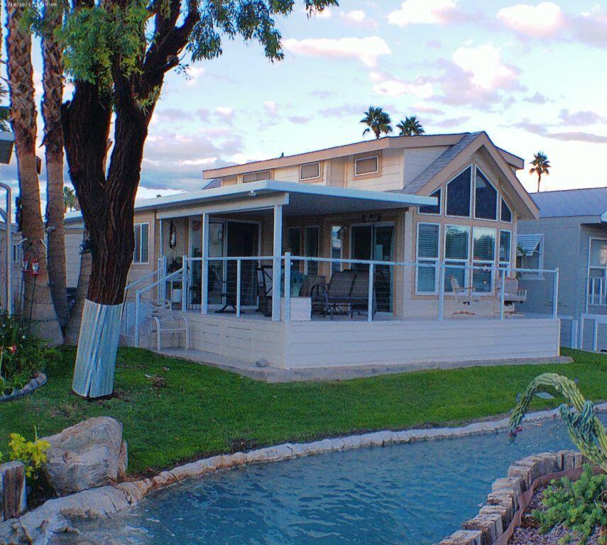 84136 Ave 44, Unit 125 Indio, CA 92203 - Photo 5 of 71 a front view of a house with a garden and plants