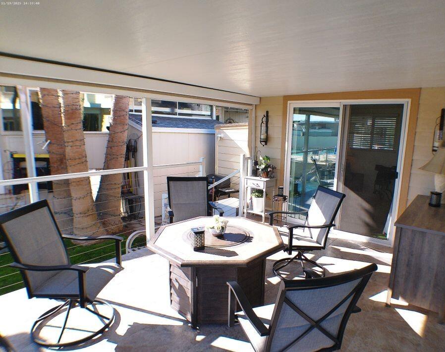 84136 Ave 44, Unit 125 Indio, CA 92203 - Photo 53 of 71 a living room with fireplace furniture and floor to ceiling windows