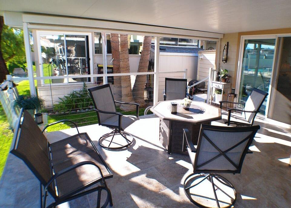 84136 Ave 44, Unit 125 Indio, CA 92203 - Photo 54 of 71 a view of a dining room with furniture wooden floor and a chandelier
