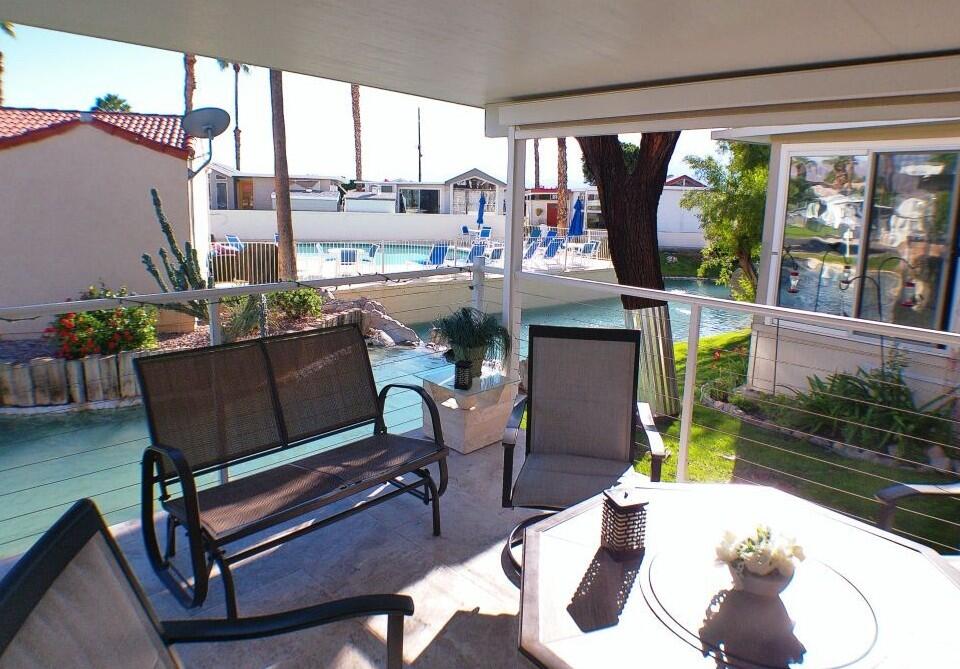 84136 Ave 44, Unit 125 Indio, CA 92203 - Photo 56 of 71 a living room with patio furniture and a potted plant