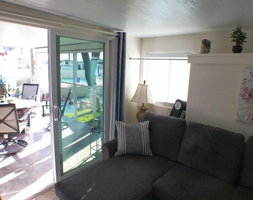 84136 Ave 44, Unit 125 Indio, CA 92203 - Photo 65 of 71 a living room with furniture and a floor to ceiling window