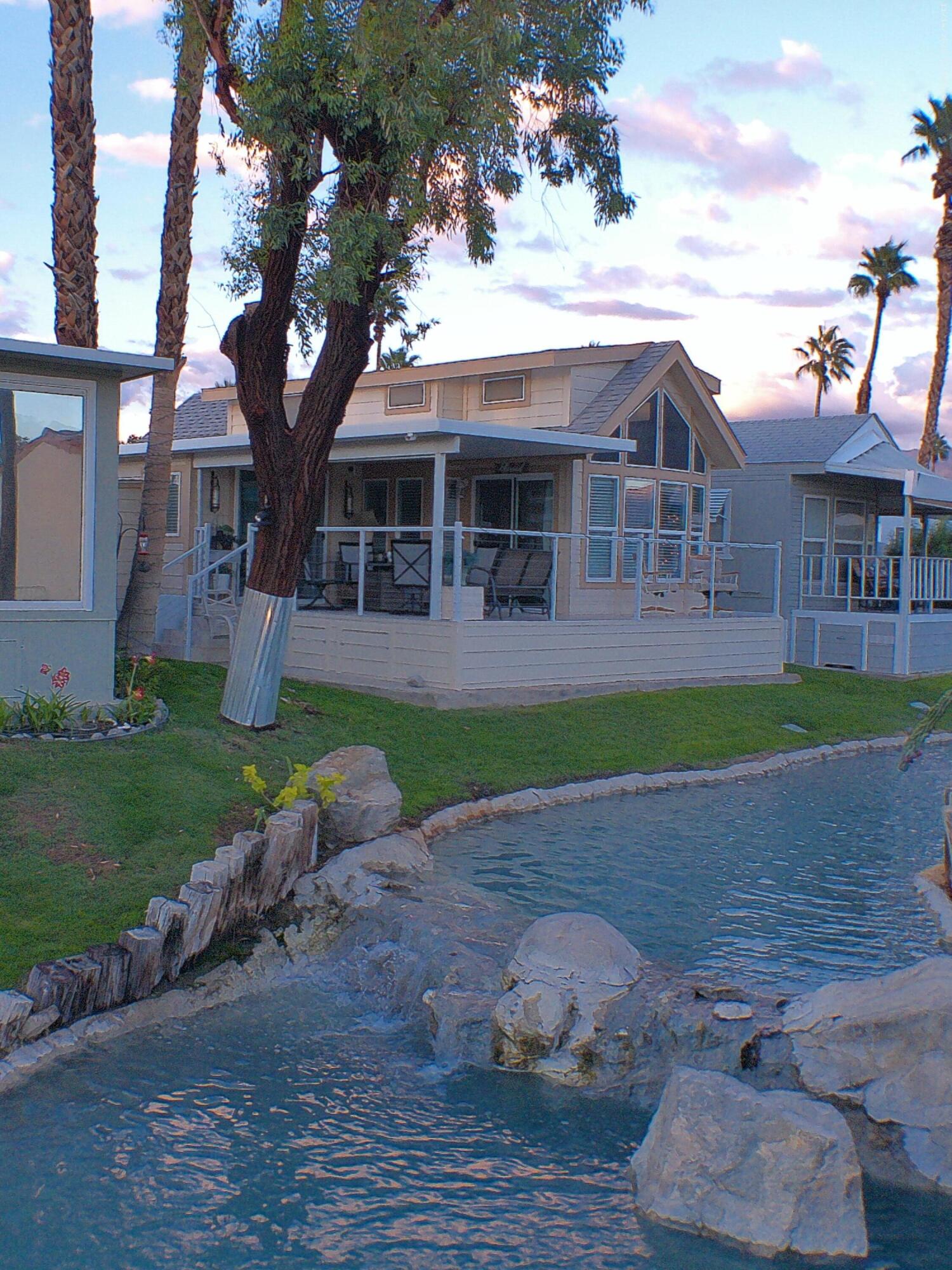 84136 Ave 44, Unit 125 Indio, CA 92203 - Photo 7 of 71 a front view of a house with a yard and garage