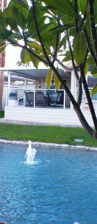 84136 Ave 44, Unit 125 Indio, CA 92203 - Photo 9 of 71 a front view of a house with a yard and a garage