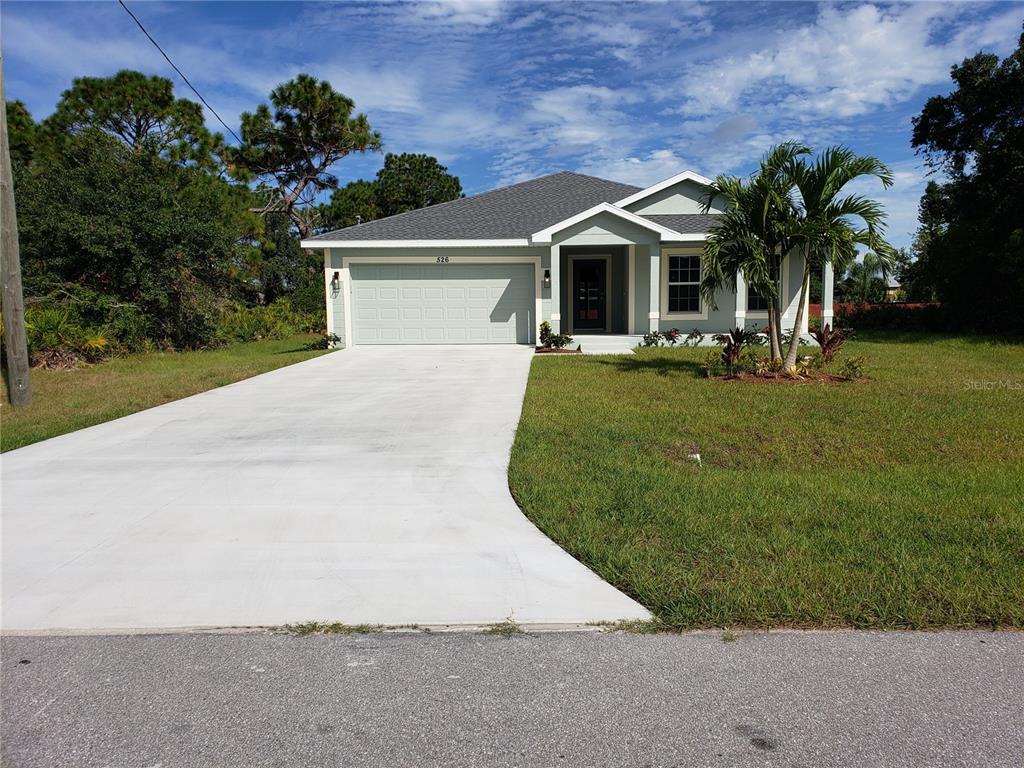 526 Sunset Road North Rotonda West, FL 33947 - Photo 1 of 1 a front view of a house with a yard and a garage