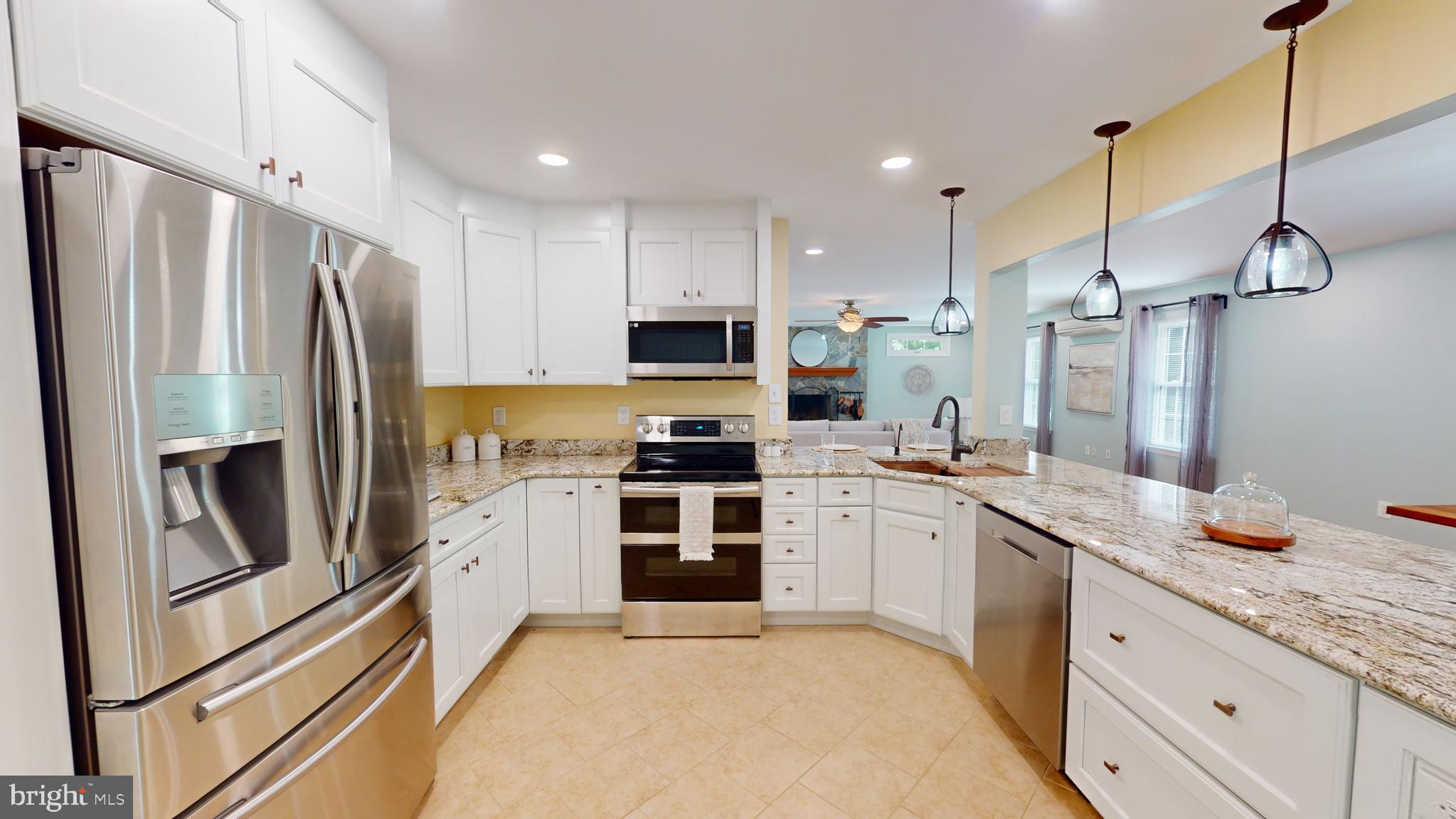 10600 Ward Road Dunkirk, MD 20754 - Photo 15 of 144 a kitchen with stainless steel appliances granite countertop a refrigerator a stove a sink and white cabinets