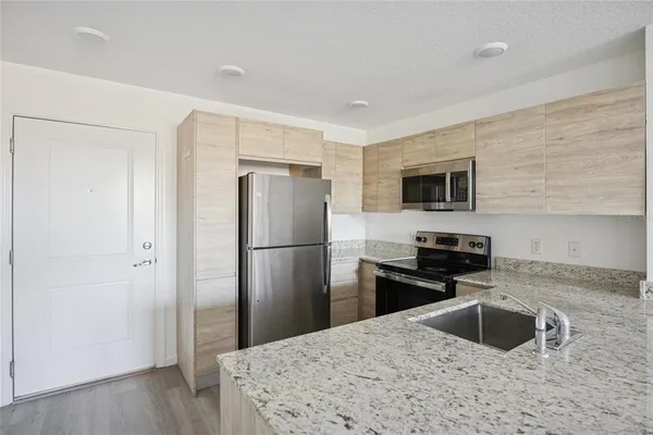 a kitchen with a refrigerator sink and microwave