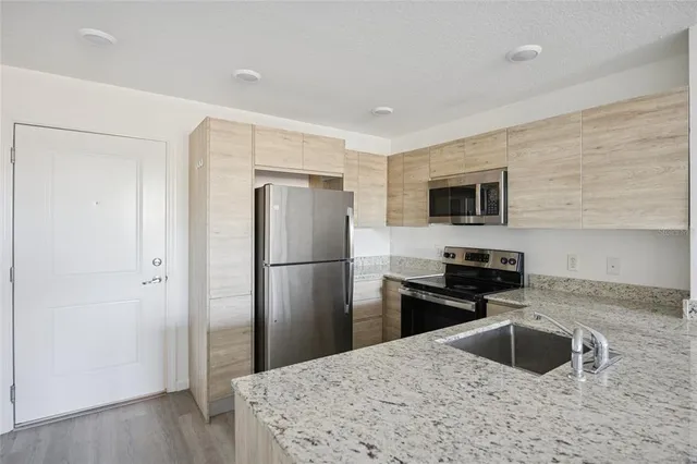 a kitchen with a refrigerator sink and microwave