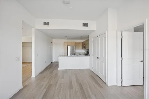 a view of a hallway with wooden floor and staircase