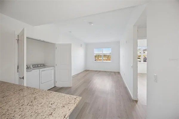 a view of kitchen and hallway with wooden floor