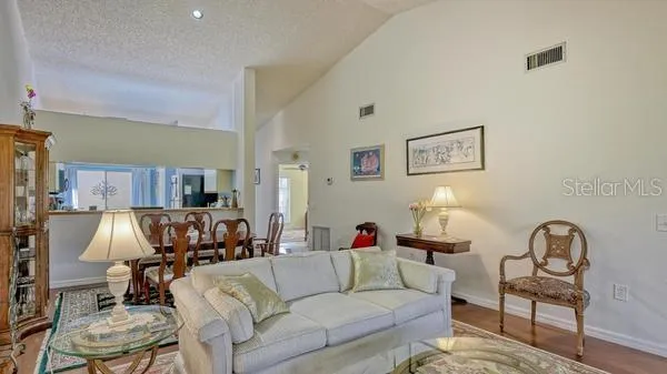 a living room with furniture and a lamp