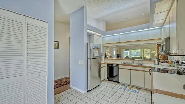 a kitchen with stainless steel appliances granite countertop a sink and cabinets