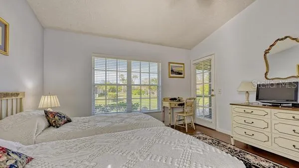 a bedroom with a bed a table and chair