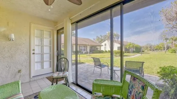 a living room with a floor to ceiling window and a table
