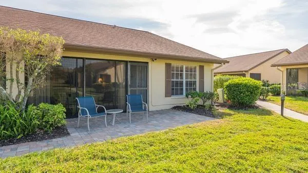 a view of a house with backyard porch and sitting area