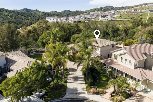 an aerial view of a house with a yard