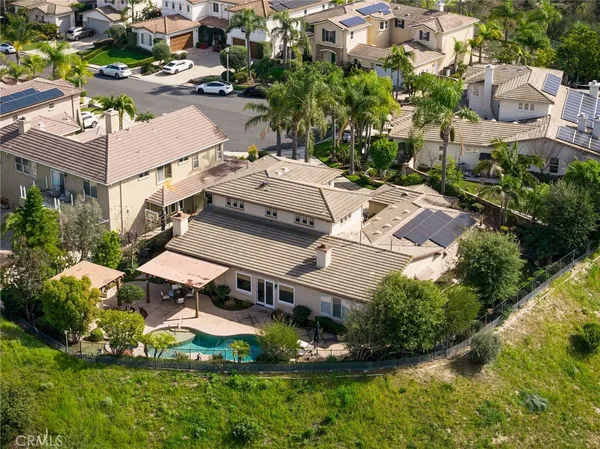 an aerial view of a house with yard swimming pool and outdoor seating