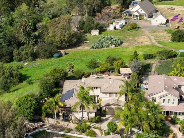 an aerial view of residential houses with outdoor space and street view
