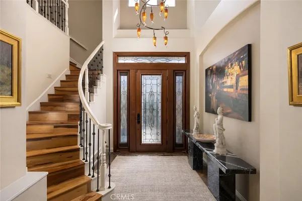 a view of a hallway with wooden floor and entryway
