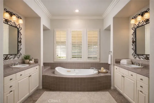a bathroom with a tub sink and mirror