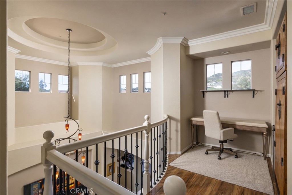 29031 Bouquet Canyon Road Silverado, CA 92676 - Photo 10 of 26 a workspace with wooden floor and a chandelier