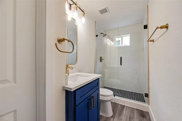 a bathroom with a sink toilet and shower
