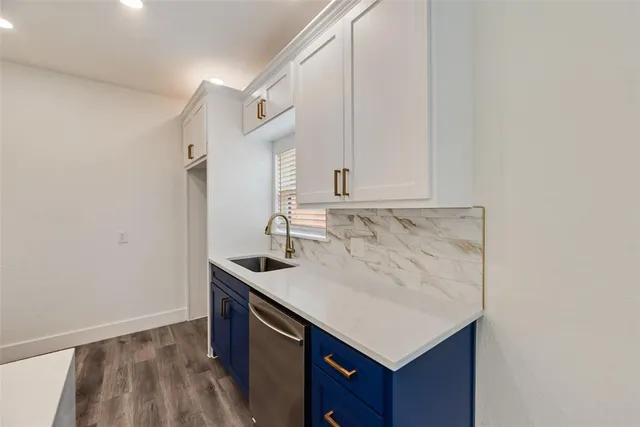 a kitchen with a sink cabinets and a window