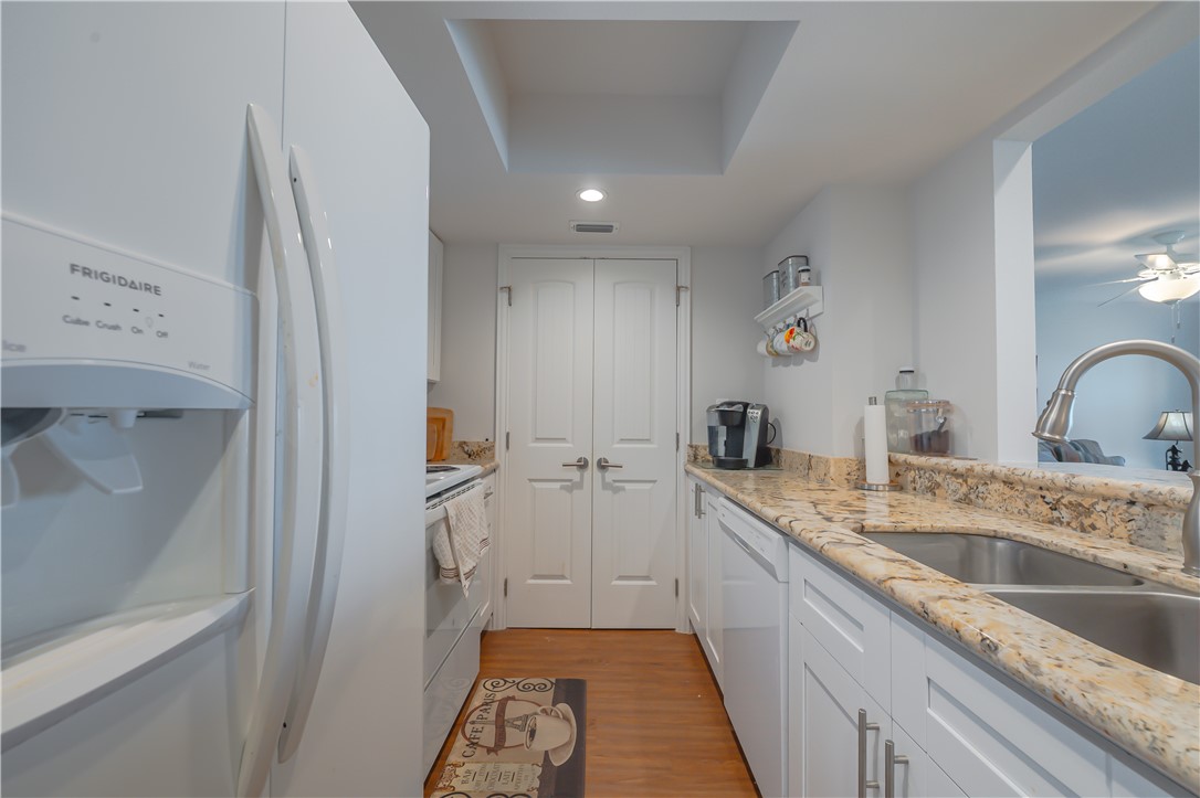 620 Fulton Beach Road, Unit 708 Rockport, TX 78382 - Photo 14 of 38 a large white kitchen with a sink and a refrigerator