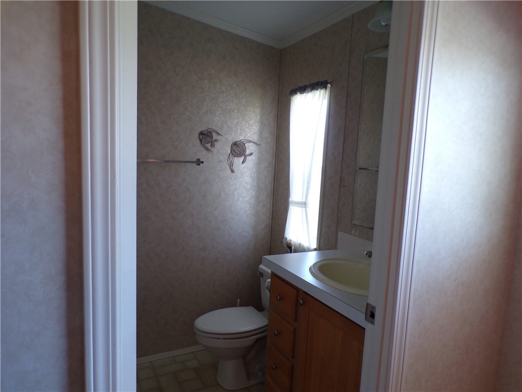 1126 Barefoot Circle Barefoot Bay, FL 32976 - Photo 12 of 16 a bathroom with a sink toilet and shower